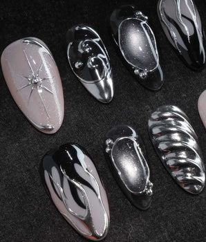 Mercury press on nails with sculpted mirror chrome swirls and outlines over smoke grey and black with a silver starburst on nude - image 1