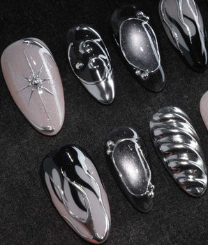 Mercury press on nails with sculpted mirror chrome swirls and outlines over smoke grey and black with a silver starburst on nude - image 1