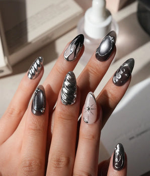 Mercury press on nails with sculpted mirror chrome swirls and outlines over smoke grey and black with a silver starburst on nude - image 2