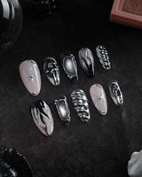 Mercury press on nails with sculpted mirror chrome swirls and outlines over smoke grey and black with a silver starburst on nude - image 3
