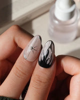 Mercury press on nails with sculpted mirror chrome swirls and outlines over smoke grey and black with a silver starburst on nude - image 4