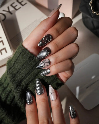 Mercury press on nails with sculpted mirror chrome swirls and outlines over smoke grey and black with a silver starburst on nude - image 5