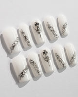 Metallic nail designs in white and silver tones for a chic look.