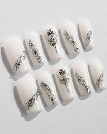 Metallic nail designs in white and silver tones for a chic look.