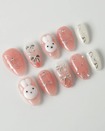 Miffy Sweetie press-on nails in extra short almond shape — Sweet Pink-Orange, 3D Bunny & Silver Bows.