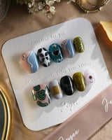 Mindbend surreal summer nails with twisting paths, chrome details, and retro shapes