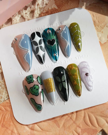 Mindbend dreamlike press-on nails with earthy tones, raised accents, and retro geometry