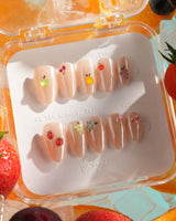 Mini Fruit extra short almond press-on nails with nude chrome and tiny 3D fruits