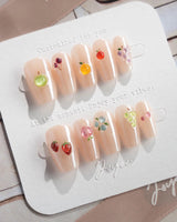 Mini Fruit quiet luxury nude nails with mini fruit charms and cat-eye gloss