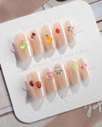 Mini Fruit quiet luxury nude nails with mini fruit charms and cat-eye gloss