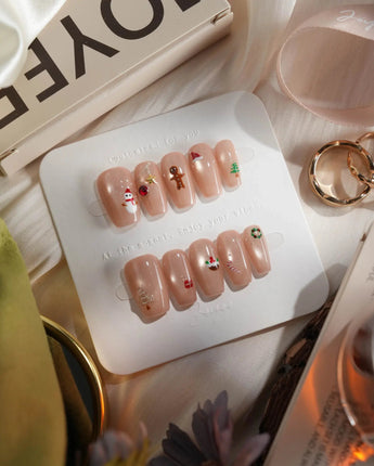 Mini Noel press-on nails in short coffin shape — nude cat eye christmas icons