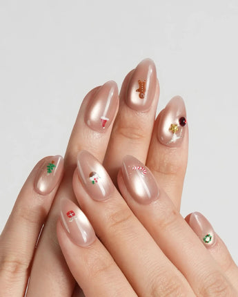 Mini Noel nail art close-up showing nude cat eye christmas icons details