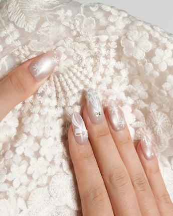 Snowfall press-on nails — pearl nude cat eye snowflake bow silver glitter soft sheen handmade nail art by Joyee Nails