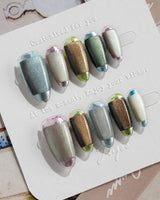 Mirrorplay hand-painted nails with metallic reflection blocks and short oval silhouette