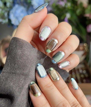 Mirrorplay sci-fi nails with reflective color blocks and shifting mirrored cat-eye effects