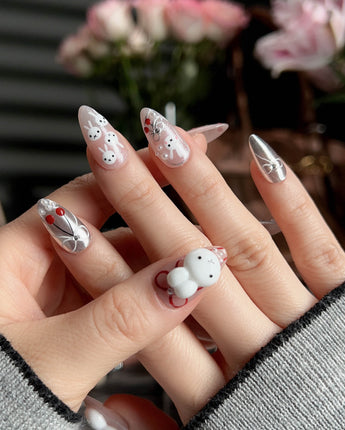Miss Miffy short almond press-on nails with nude base, silver metallic accents and 3D rabbit