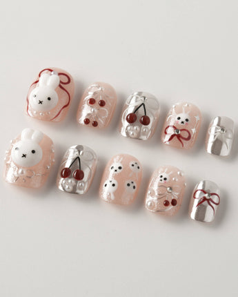 Miss Miffy extra short squoval press-on nails with nude base, rabbit and cherry details