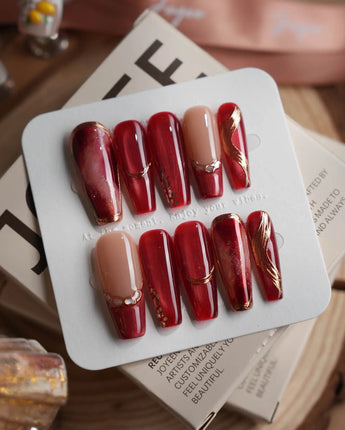 Molten Rouge long coffin press-on nails with deep red cat-eye and crystal accents