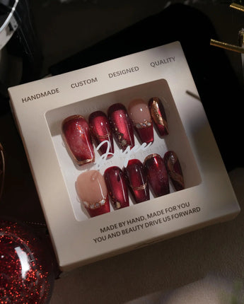 Molten Rouge medium coffin press-on nails with red cat-eye, gold outlines and crystals