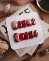 Molten Rouge short square press-on nails with deep red cat-eye and gold crystal details