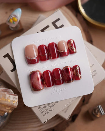 Molten Rouge short square press-on nails with deep red cat-eye and gold crystal details