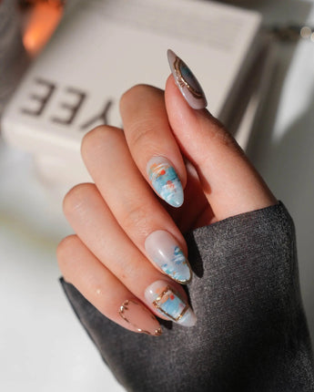 Monet Sunrise handmade press-on nails with blue water scene and gold accents