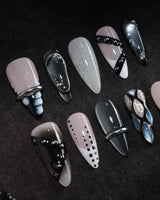 Monochrome press on nails mixing black and white marble, liquid chrome, polka dots, silver beads and a chrome bar across ten nails - image 1