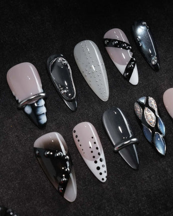Monochrome press on nails mixing black and white marble, liquid chrome, polka dots, silver beads and a chrome bar across ten nails - image 1