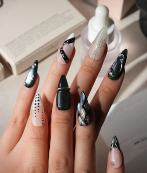 Monochrome press on nails mixing black and white marble, liquid chrome, polka dots, silver beads and a chrome bar across ten nails - image 2