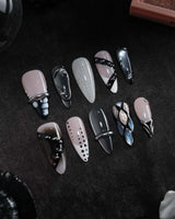 Monochrome press on nails mixing black and white marble, liquid chrome, polka dots, silver beads and a chrome bar across ten nails - image 3