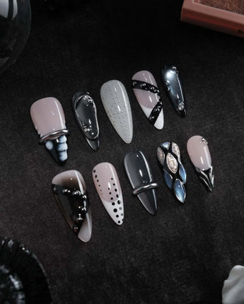 Monochrome press on nails mixing black and white marble, liquid chrome, polka dots, silver beads and a chrome bar across ten nails - image 3