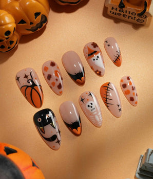 Monster Mash handmade Halloween press on nails with orange pumpkin, vampire, skeleton, stitches and bats on a sheer nude base - image 2