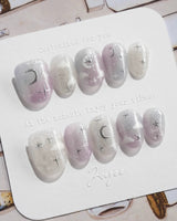 Moonrest medium almond nail set with pink white ombre and silver celestial accents