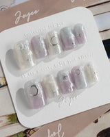 Moonrest hand-painted celestial nails with silver stars and dreamy pastel ombre