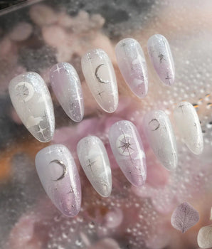 Moonrest handmade press-on nails featuring Pink and white ombre with glitter, silver stars, and a moon