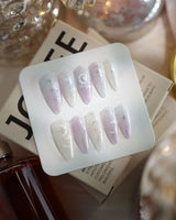 Moonrest medium stiletto nails with pink white ombre, glitter, and moon detail