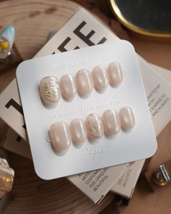 Morning Air press-on nails in extra short oval shape — Fresh Creamy Nude, Hand-painted Metallic Daisies & Simple gold Wire.