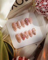 Neon Kiss press-on nails with luminous pink chrome, pearls and dimensional butterfly wing art