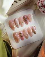 Neon Kiss press-on nails with glossy pink chrome, pearl dots and raised butterfly linework