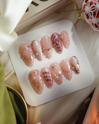 Neon Kiss press-on nails with glossy pink chrome, pearl dots and raised butterfly linework