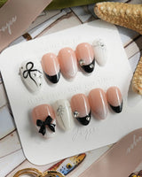 New Year Glam press-on nails in extra short almond shape — Classic Black & White, 3D Bows & French Outlines.