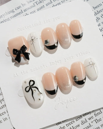 New Year Glam press-on nails in extra short oval shape — Classic Black & White, 3D Bows & French Outlines.