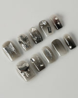 Night Butterfly press-on nails in extra short square shape — black ombre chrome 3D gothic nails