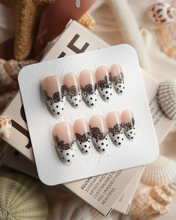 Noir Lace custom-size medium almond nails with black polka dots and lace art