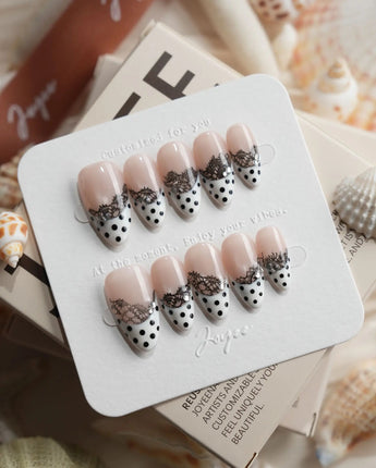 Noir Lace short almond press-on nails with dotted white tips and black lace