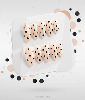 Dot Noir-Mini nails with nude and black contrast and crisp retro polka-dot pattern