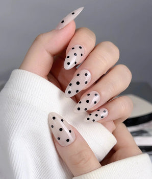 Dot Noir press-on nails with nude and black contrast and retro polka dot design