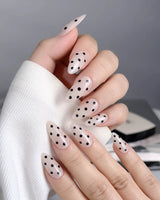 Dot Noir press-on nails with minimalist nude and black contrast and glossy polka dots