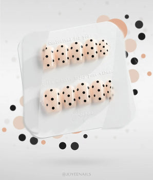 Dot Noir-Mini press-on nails with nude base, black contrast, and retro polka-dot art