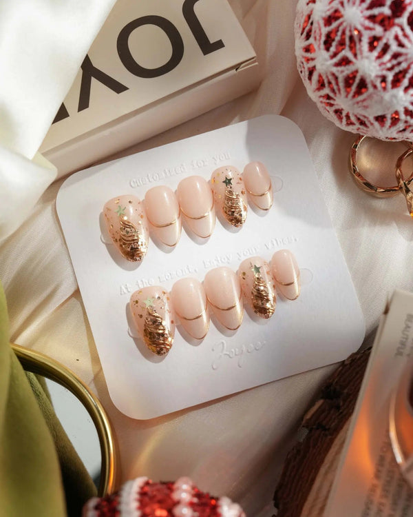 Nude cat-eye holiday nails with metallic gold edge